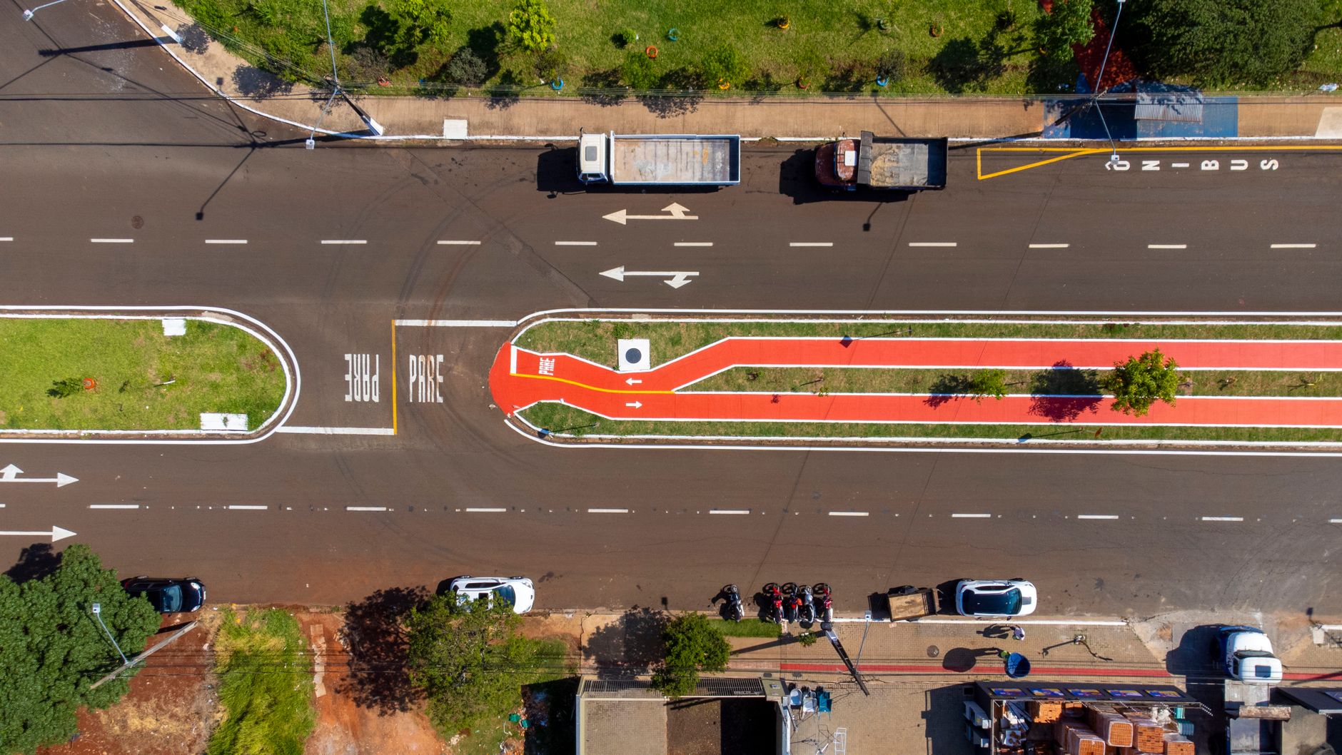 Veduta aerea di una strada urbana con pista ciclabile segnalata, intersezioni e flusso traffico